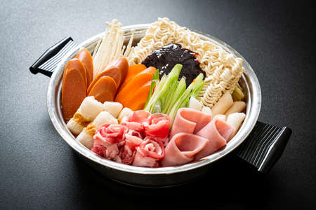 Budae jjigae or budaejjigae (army stew or army base stew). it is loaded with kimchi, spam, sausages, ramen noodles and much more - popular korean hot pot food style
