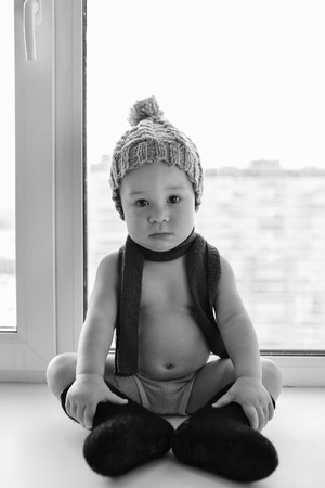 Adorable One Year Old Baby Boy Lonely Sitting On The Windowsill