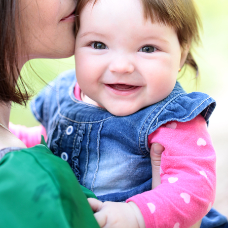 small cute baby girl with pretty smiling face and funny eyes stock