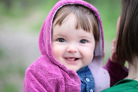 small cute baby girl with pretty smiling face and funny eyes stock