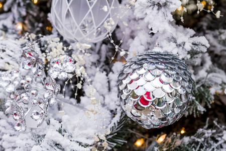 shiny silver christmas ornament hanging on frosted white christmas frosted christmas ornaments