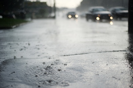 дождь: Puddle near the wet road in the rain Фото со стока