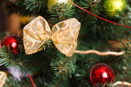 Beautiful Golden Bow And Red Green Christmas Balls On Artificial Tree Close Up Detail Beautiful Golden Bow And Red Green Christmas Balls On Artificial Tree Close Up Detail