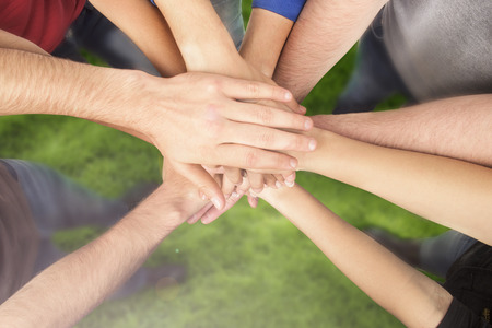 multiracial group of friends with hands in stack teamwork banco de
