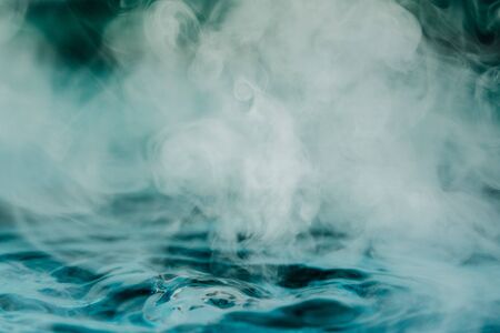 Teal blue abstract background with steam and water