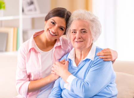 Care of senior woman at home sitting on the couch