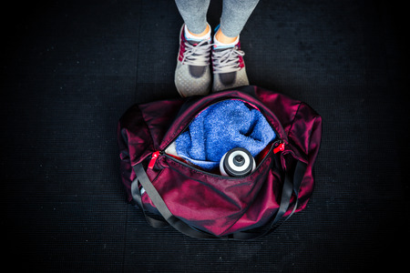 Closeup image of fitness bag with female legs Imagens