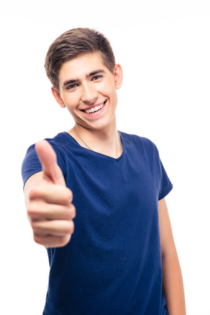 Happy casual man showing thumb up isolated on a white background. Looking at camera Фото со стока