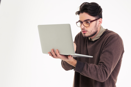 Portrait of a funny man using laptop compter isolated on a white background