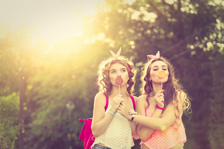 best friends the girls hide their lips for lollipops girls stock