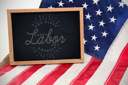 Composite image of happy labor day and god bless america text against blank chalkboard on american flag