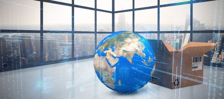 Brown cardboard boxes by planet earth against room with large window showing city
