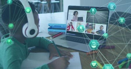 Image of globe of digital icons on african american boy doing homework looking at laptop at home school and education technology concept