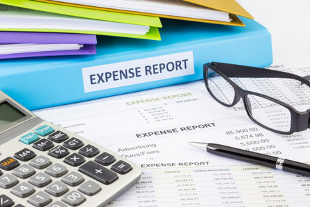 business expense report binder with financial documents and