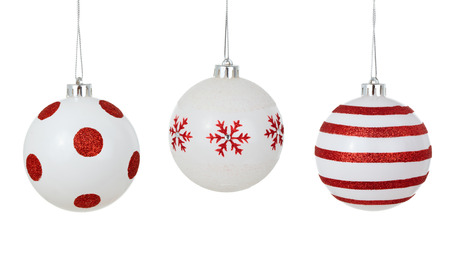 stock photo white christmas balls with painted red patterns hanging in a row isolated on white background - White Christmas Balls stock photo white christmas balls with painted red patterns hanging in a row isolated on white background - White Christmas Balls