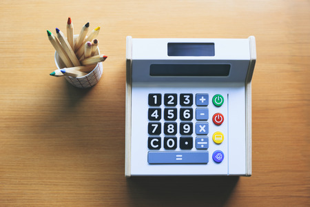 calculator with color pencils on table money saving budget control financial management calculator