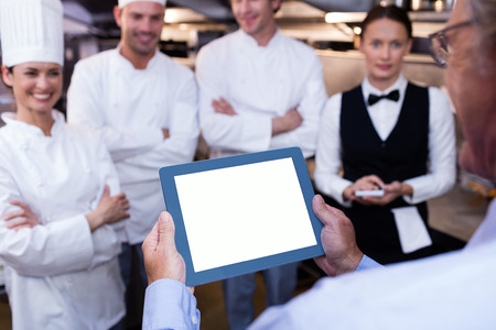Restaurant Kitchen Staff restaurant manager briefing to his kitchen staff in the commercial Restaurant Kitchen Staff restaurant manager briefing to his kitchen staff in the commercial