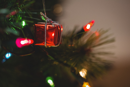 close up of fairy light and small gift box hanging on christmas tree stock photo - Small Light Up Christmas Decorations close up of fairy light and small gift box hanging on christmas tree stock photo - Small Light Up Christmas Decorations