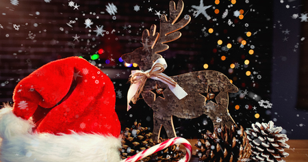 snow falling against christmas decorations with wooden reindeer on table stock photo 64442507 - Wooden Deer Christmas Decorations snow falling against christmas decorations with wooden reindeer on table stock photo 64442507 - Wooden Deer Christmas Decorations