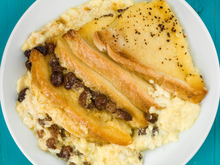 Traditional Bread and Butter Pudding Baked Dessert Against a Blue Wooden Background Фото со стока