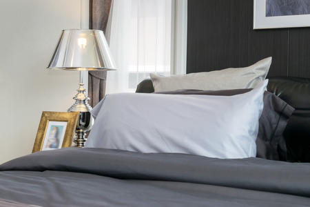 Stylish bedroom interior design with brown patterned pillows on ... Hálószoba olvasólámpa