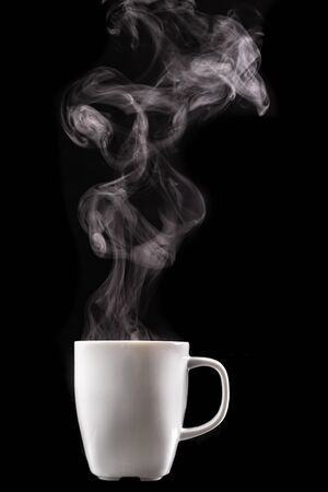 A white mug of warm drink and steam. tasty hot coffee on a dark table. black background.