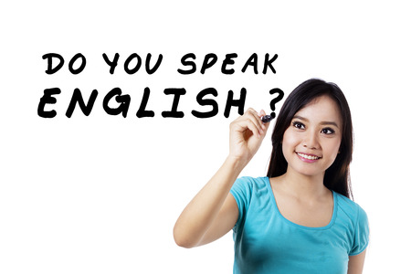 Learning language concept. Female student write Do You Speak English?