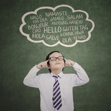 Education concept: schoolboy learn multilanguage at class