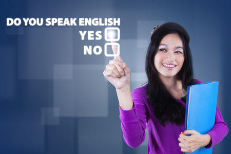 Image of beautiful teenage girl learn english speaking and touching a text of Do You Speak English? Stock Photo