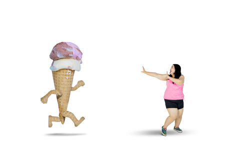 Diet concept. Fat woman running away from an ice cream, isolated on white background - 101409999