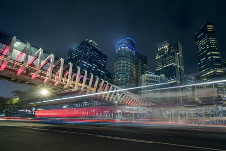 Image of beautiful new pedestrian bridge with skyscrapers at night time in Jakarta city - 121854581