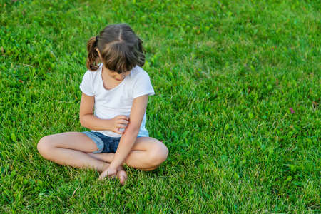 child is bitten by mosquitoes. Selective focus. nature.