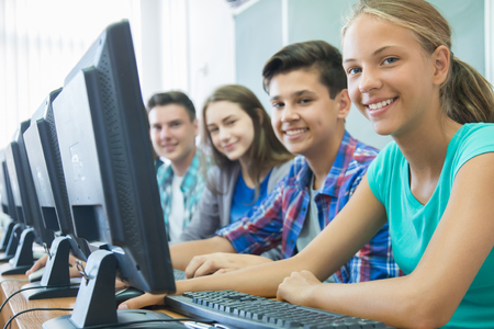 Group of students working at computers in classroom Stock Photo - 45903140