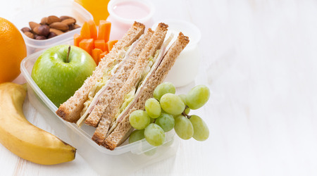 school lunch with sandwiches and fruit on white background, close-up - 43845394