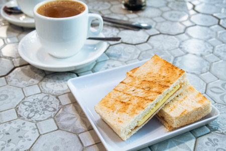 Toast de petit-déjeuner avec café et pain grillé avec du beurre et du kaya, un petit-déjeuner typique au café
