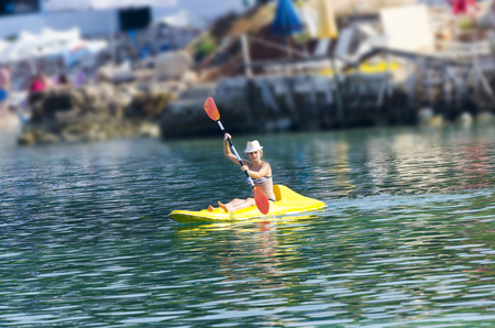 kayaking a woman in a kayak girl paddling in the calm sea water