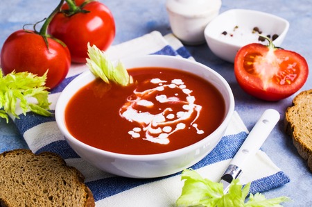 Traditional tomato soup with cream in a plate on the table. Selective focus. Stock Photo
