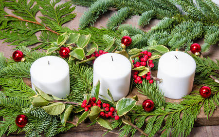 an evergreen christmas centerpiece with three white candles and holly stock photo 34163011 - An Evergreen Christmas an evergreen christmas centerpiece with three white candles and holly stock photo 34163011 - An Evergreen Christmas
