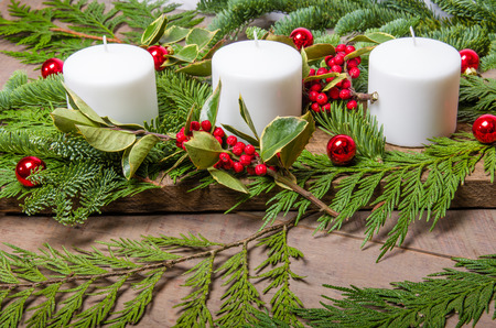 an evergreen christmas centerpiece with three white candles on wooden base stock photo 34216654 - An Evergreen Christmas an evergreen christmas centerpiece with three white candles on wooden base stock photo 34216654 - An Evergreen Christmas