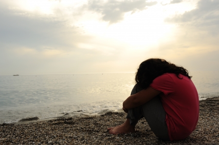 sad lonely: Lonely sad girl on the dark beach Stock Photo