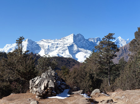 Kangtega, thamserku and ama dablam mountain view and ancient mani wall on the road to everest base camp in sagarmatha national park, nepal himalayas Stock Photo